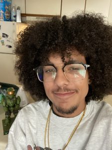diego with glasses on and a necklace