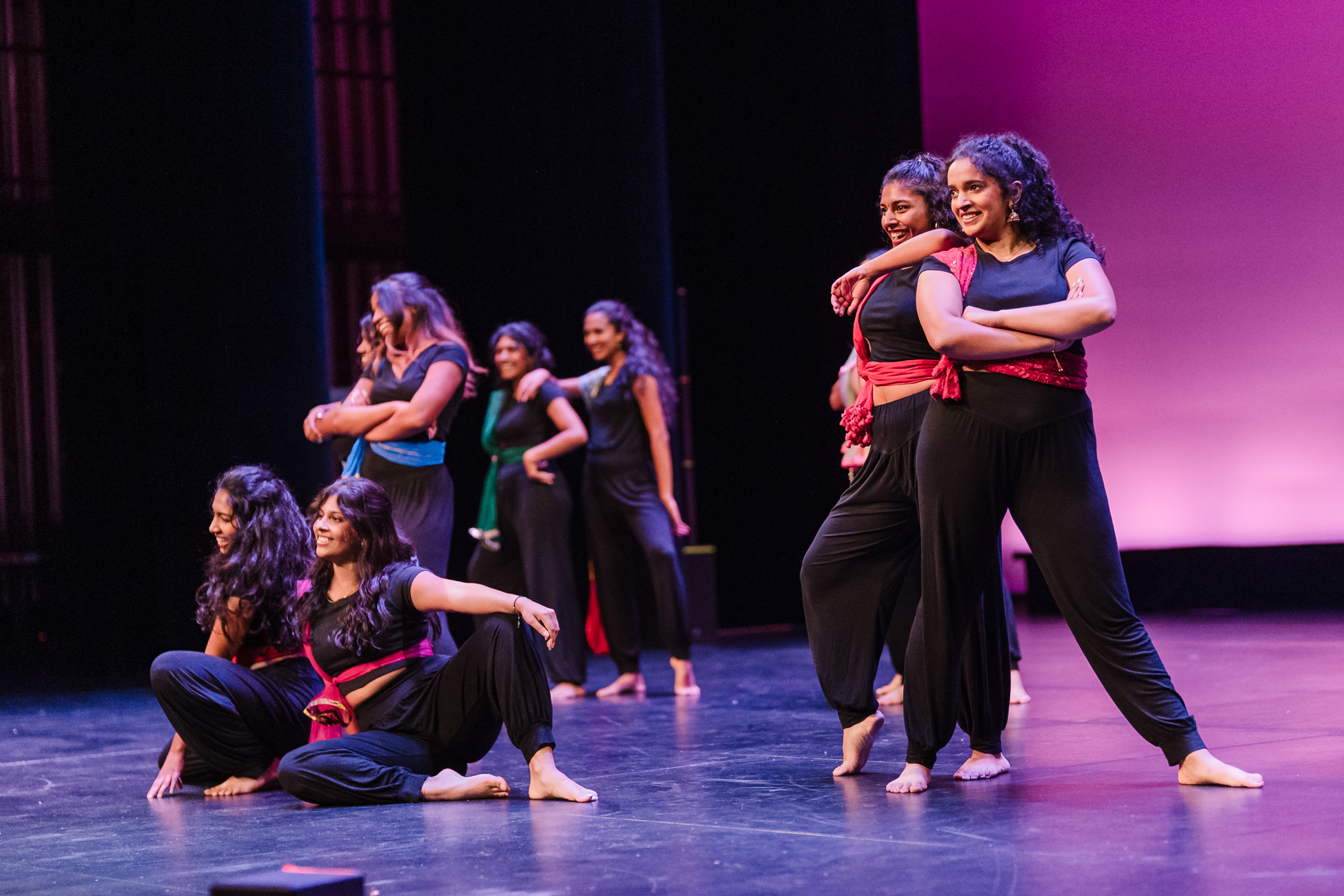 Photo of performers at MCOR. All wearing a black outfit with red bandana.