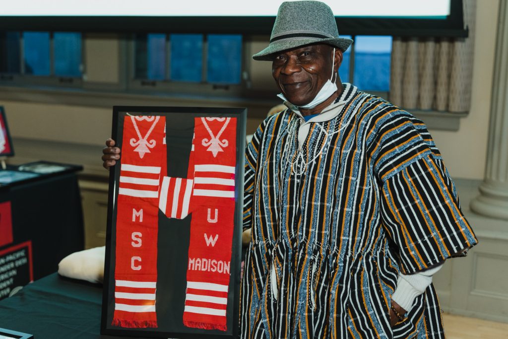 A guest at the event holding UW stoles. 