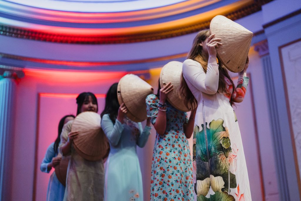 Dancers with Asian hats.