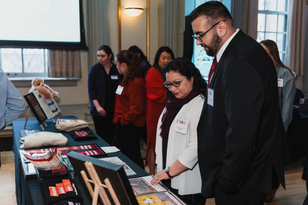 Gala attendees reviewing documents and artifacts at the gala.