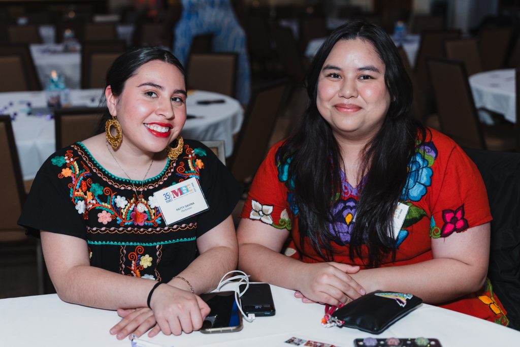 Two attendees at the gala sitting at a table.